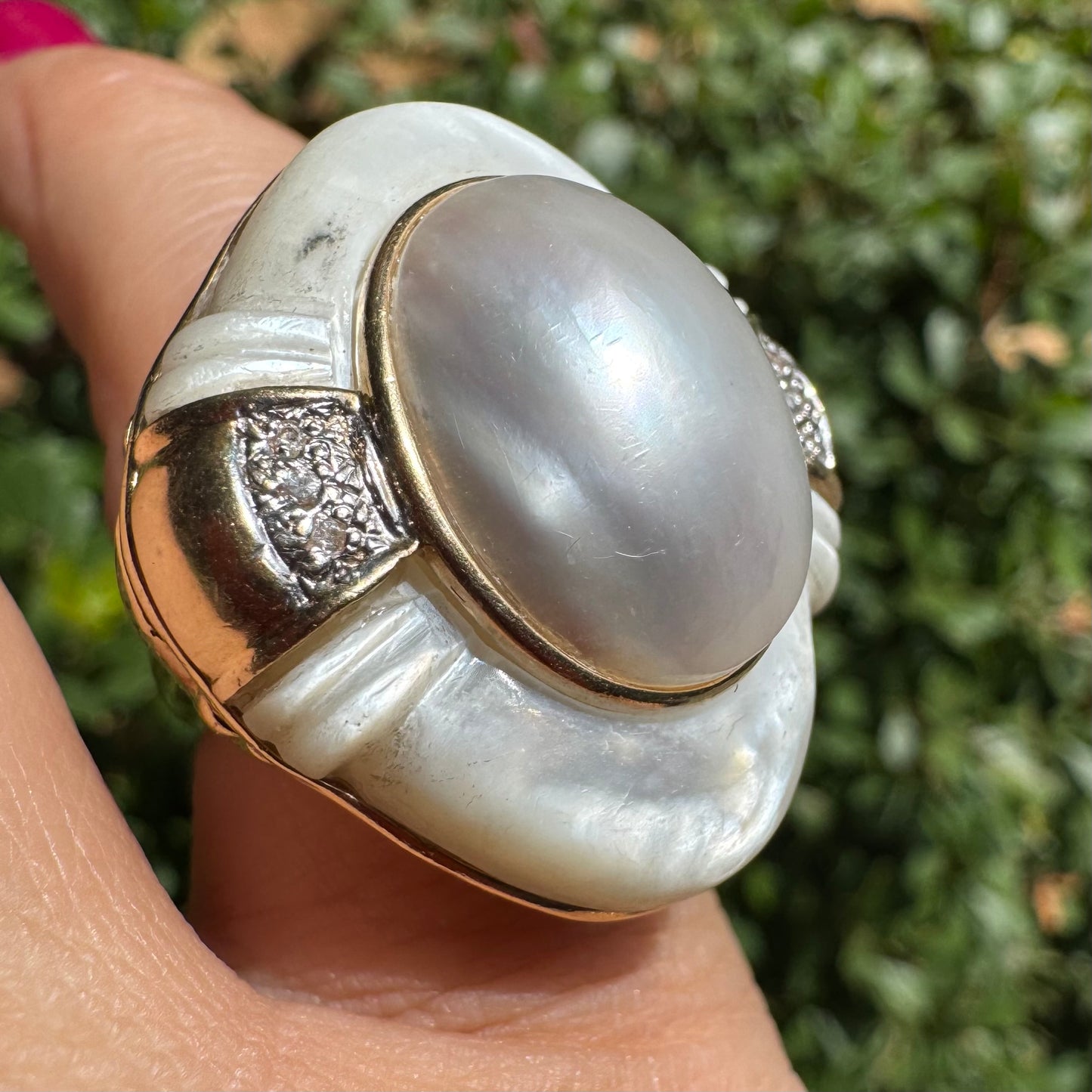 14K gold ring set with a natural mother-of-pearl centerpiece framed by delicate diamond accents