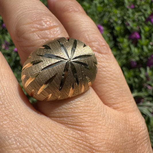 14K gold dome ring crafted in textured gold, featuring intricate engraved starburst detailing