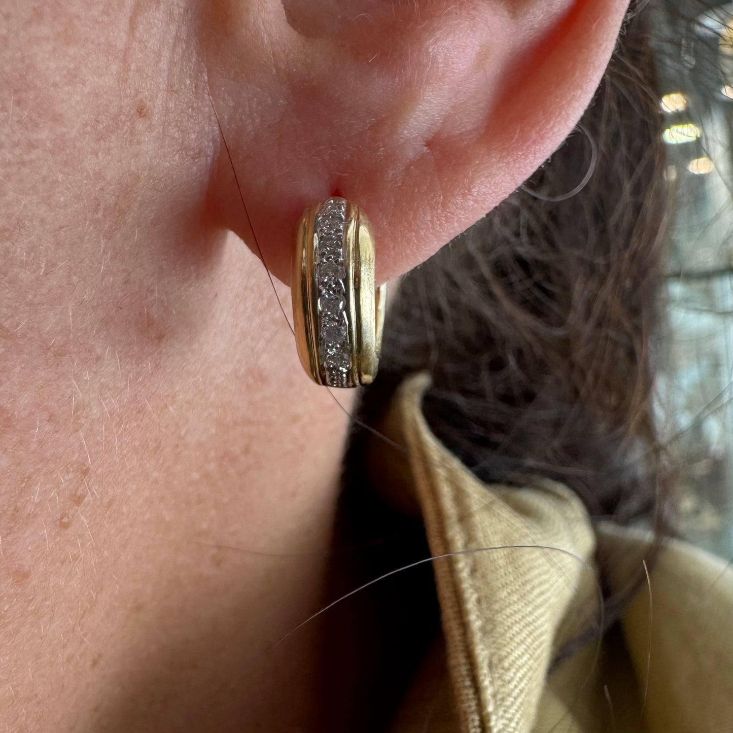 14K gold hoop earrings set with a row of sparkling Diamonds in a sleek channel setting