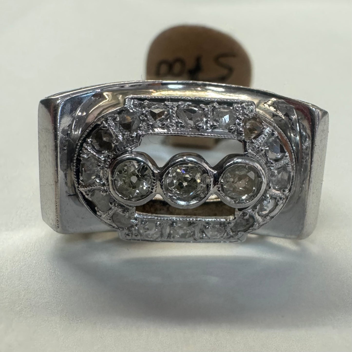 18K gold ring featuring three round 3 Diamonds in the center, framed by a rectangular halo of smaller Diamonds.