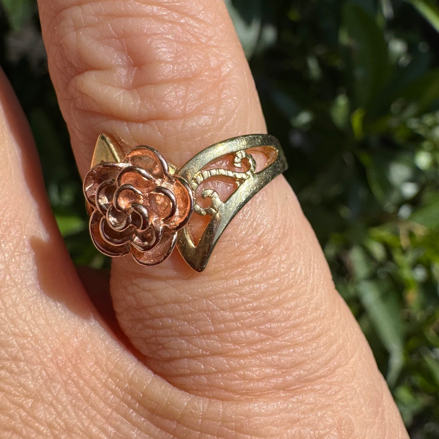 10K two tone gold with a sculpted rose at its center