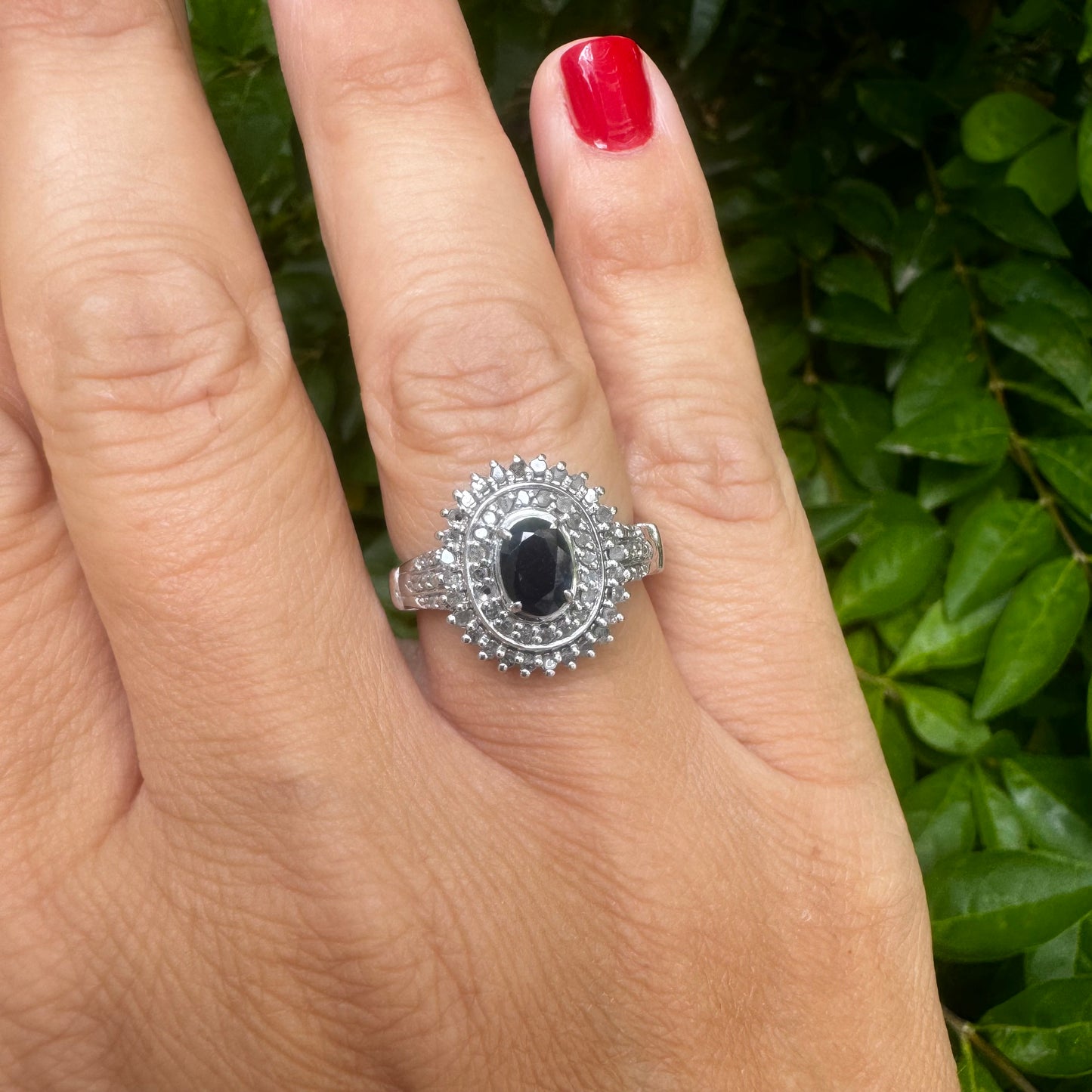 14K gold ring set with an oval-cut Sapphire, surrounded by a stunning double halo of brilliant round Diamonds