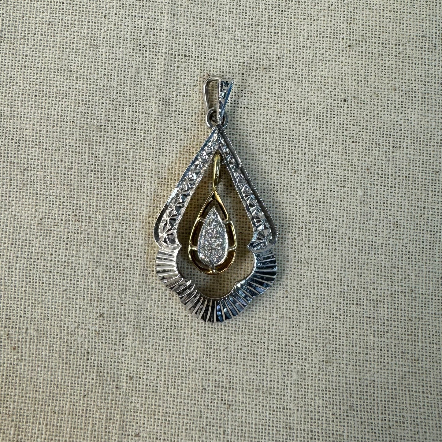 14K white and yellow gold pendant in a unique geometric design set with Diamonds