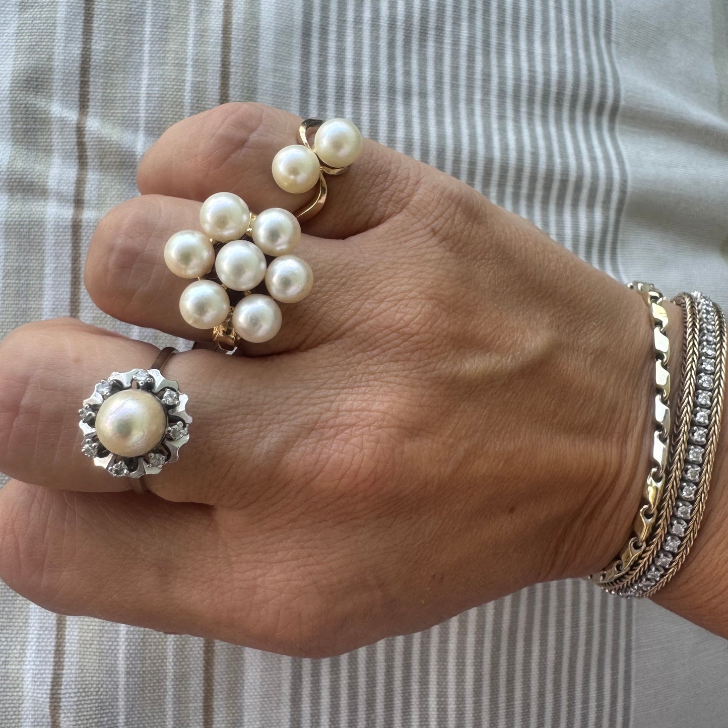 14K gold ring set with seven round Pearls in a bold floral cluster