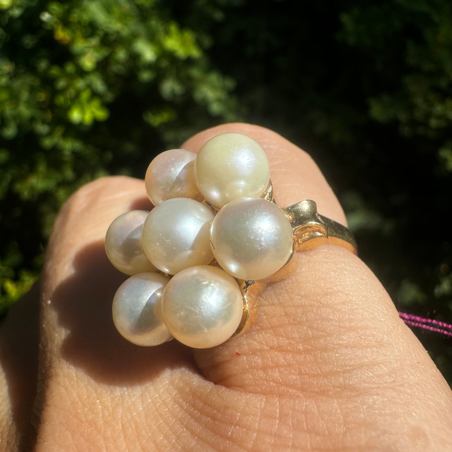14K gold ring set with seven round Pearls in a bold floral cluster