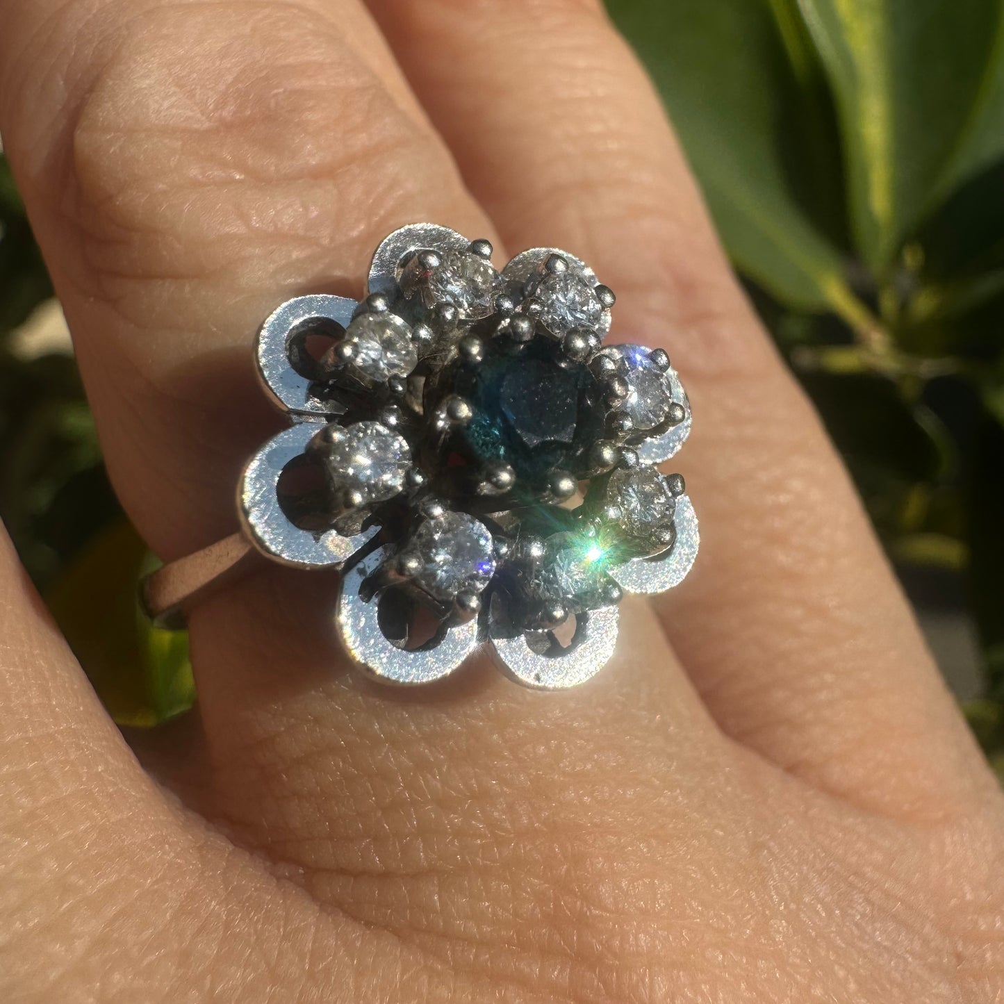 14K gold floral ring set with a round deep blue Sapphire at its center & Diamonds