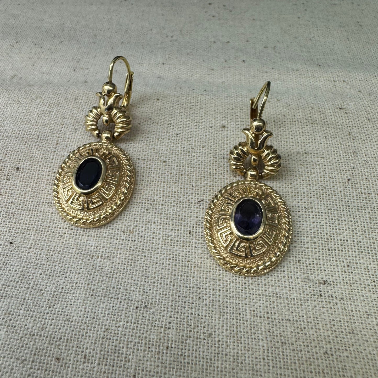 14K gold drop earrings set with Tanzanite in ornate medallion