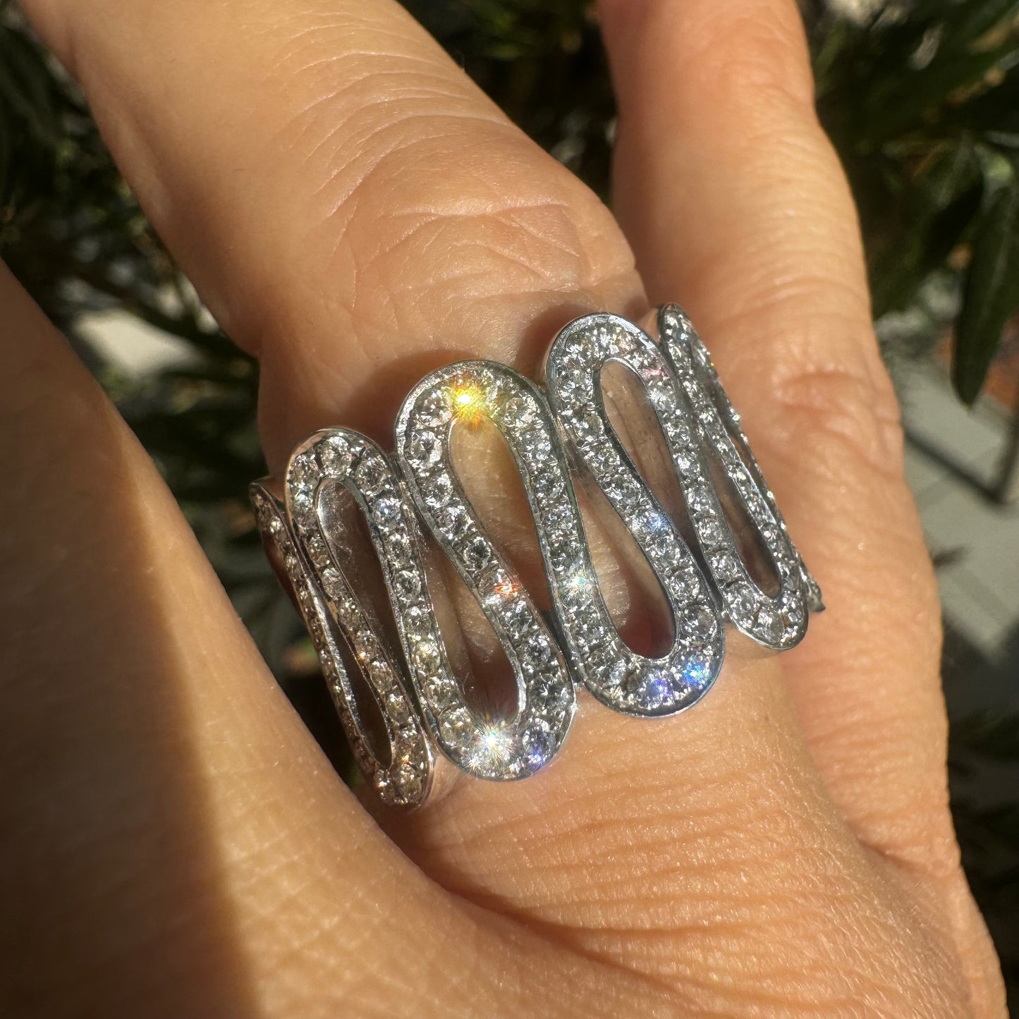 14K gold ring set with shimmering Diamonds in a flowing wave design