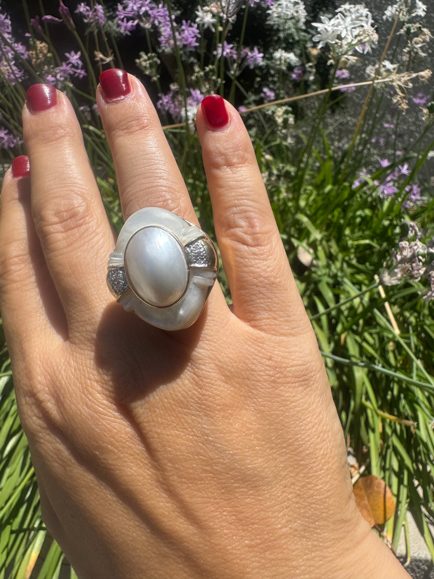 14K gold ring set with a natural mother-of-pearl centerpiece framed by delicate diamond accents