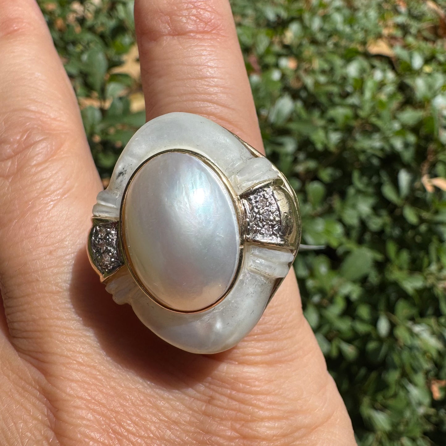 14K gold ring set with a natural mother-of-pearl centerpiece framed by delicate diamond accents