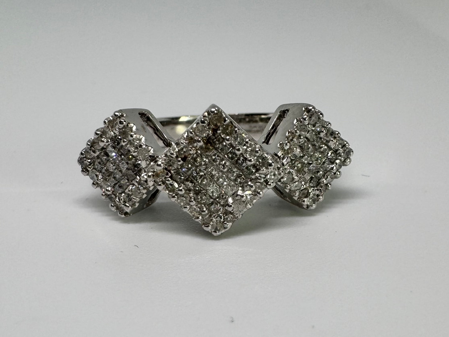 14K gold ring with three square clusters of sparkling Diamonds