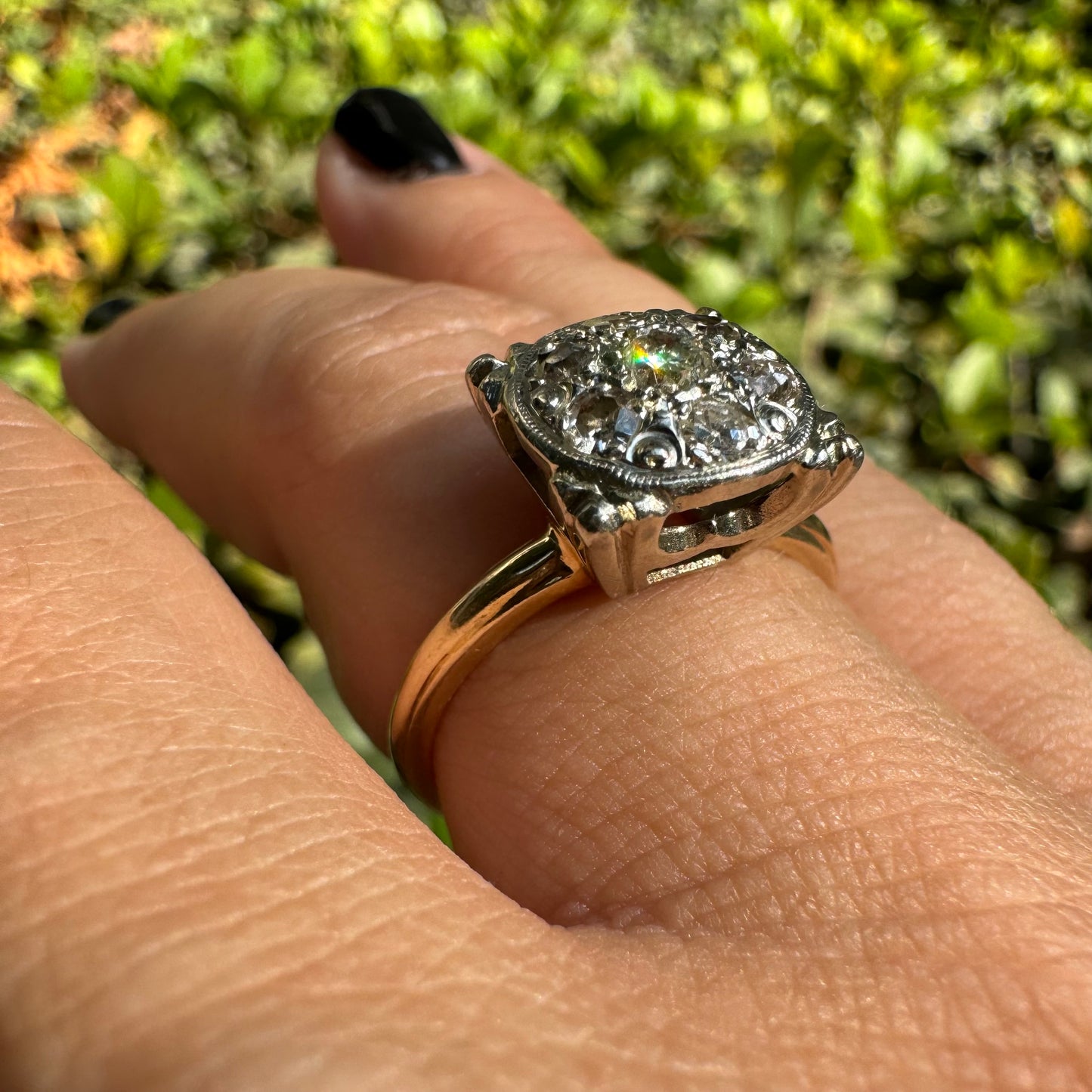 14K gold ring set with an old-cut Diamond at its center, encircled by a pavé cluster of smaller Diamonds in a round, ornate setting.