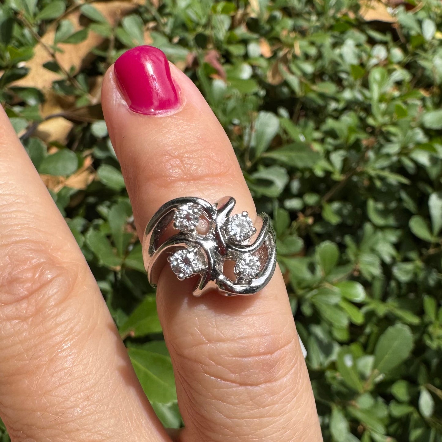 14K gold ring set with four brilliant-cut Diamonds, arranged in an elegant flowing design