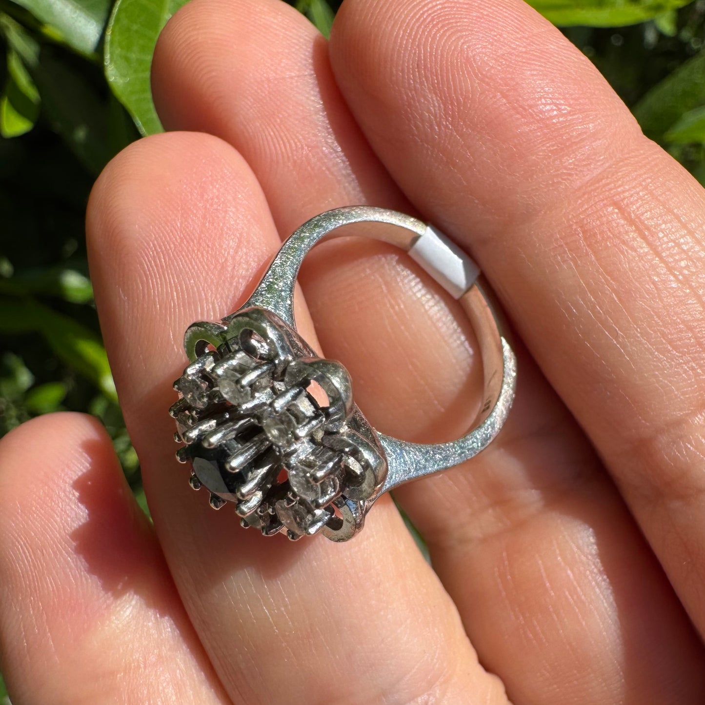 14K gold floral ring set with a round deep blue Sapphire at its center & Diamonds