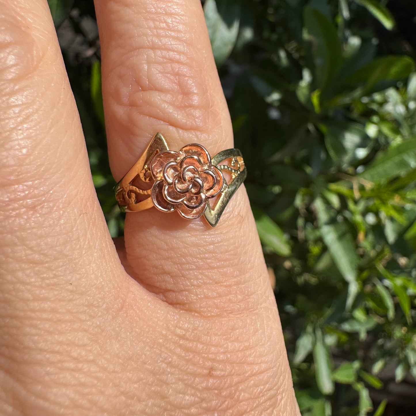 10K two tone gold with a sculpted rose at its center