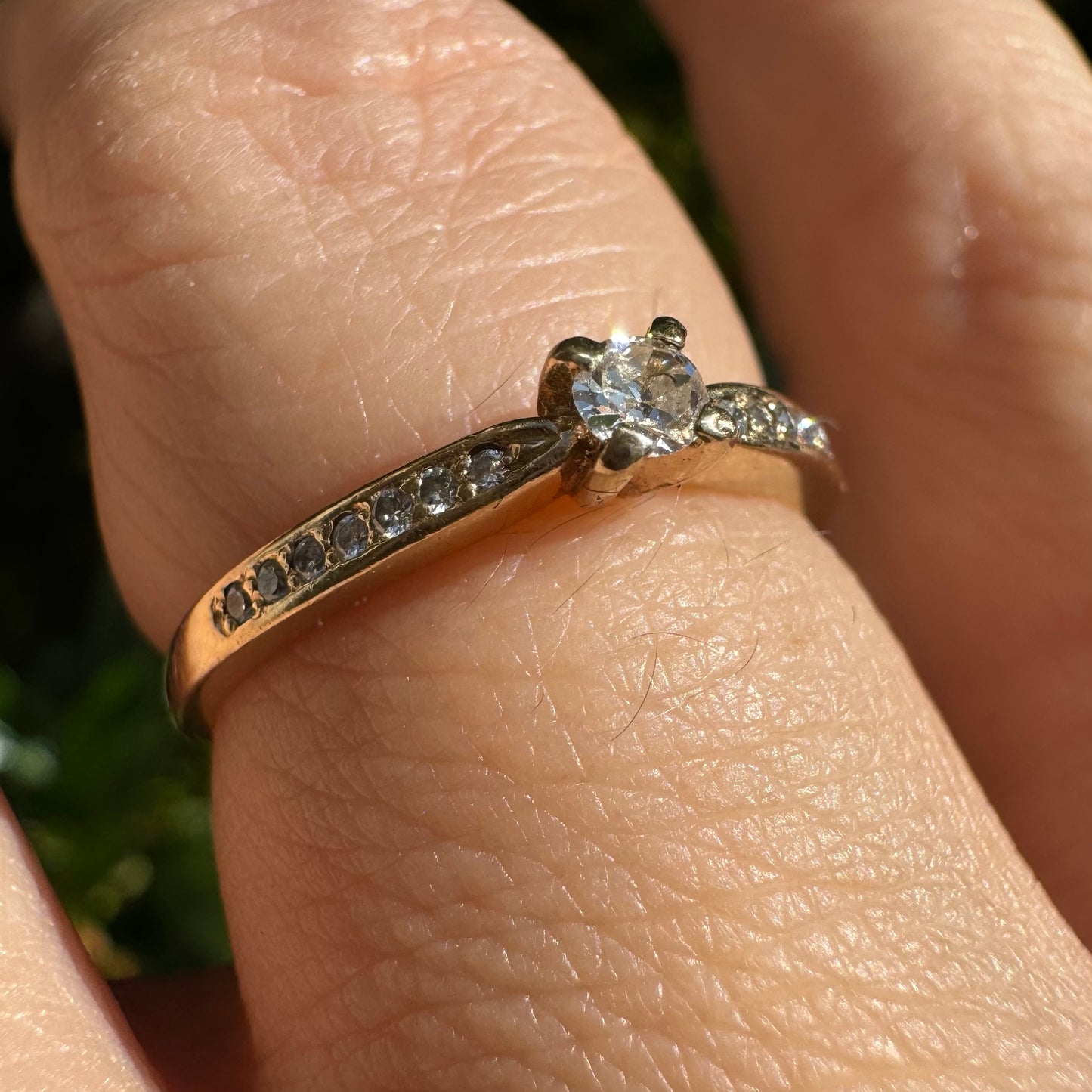 14K gold ring set with one center Diamond and side Diamonds