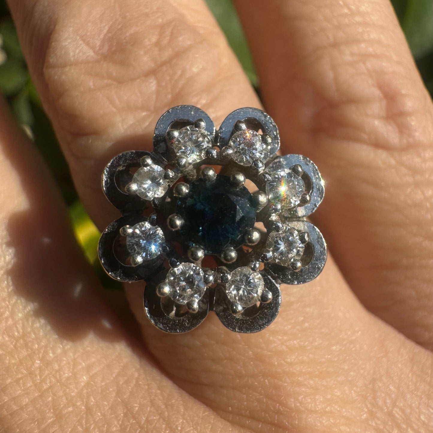 14K gold floral ring set with a round deep blue Sapphire at its center & Diamonds