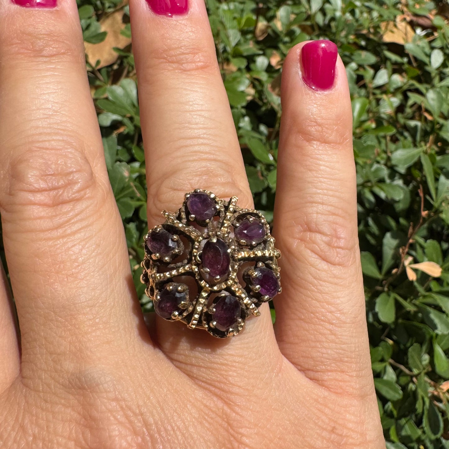 14K gold cocktail ring set with a stunning cluster of deep purple Garnet stones in marquise cuts.
