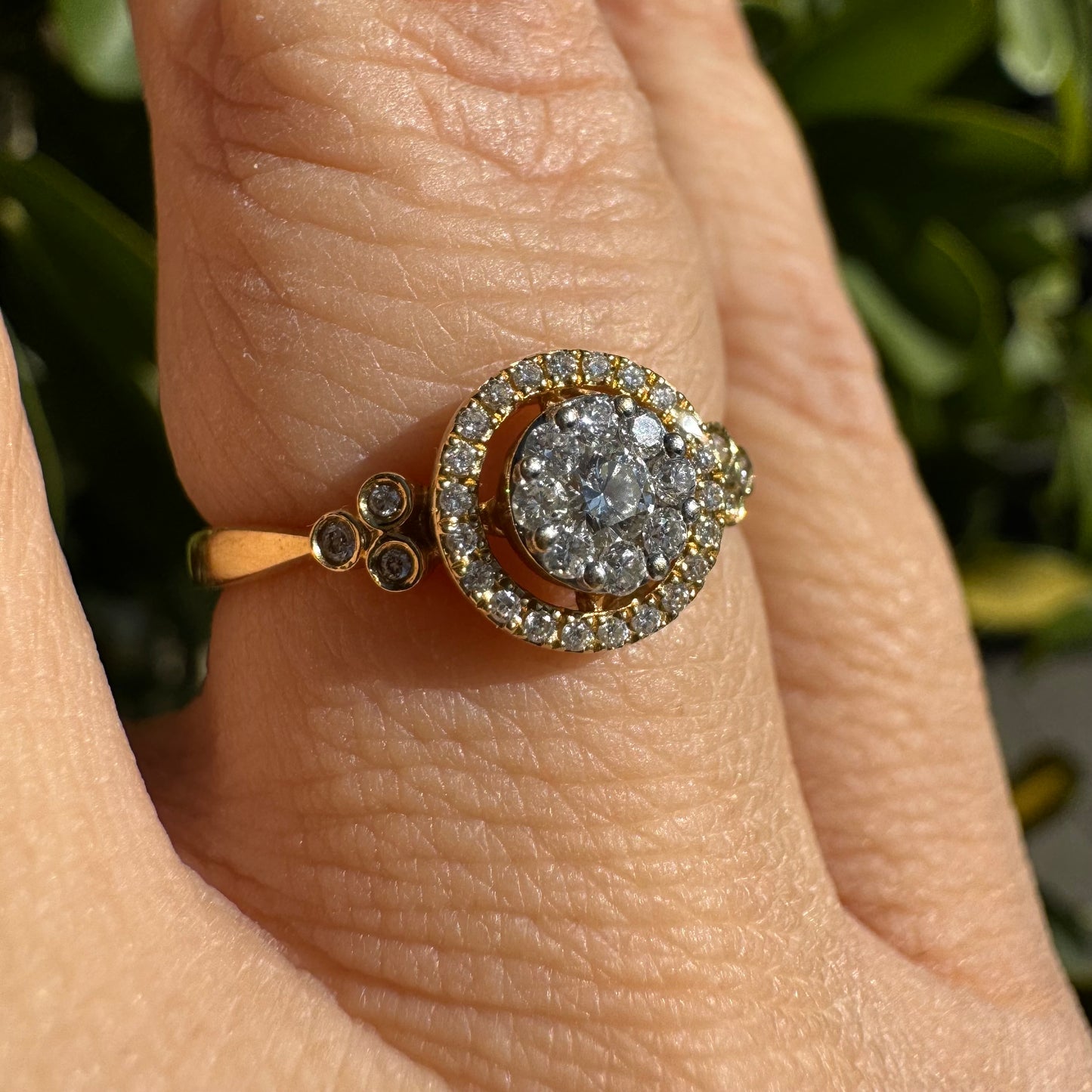 14K gold ring with a round cluster of Diamonds in the center, surrounded by a halo of smaller sparkling Diamonds.