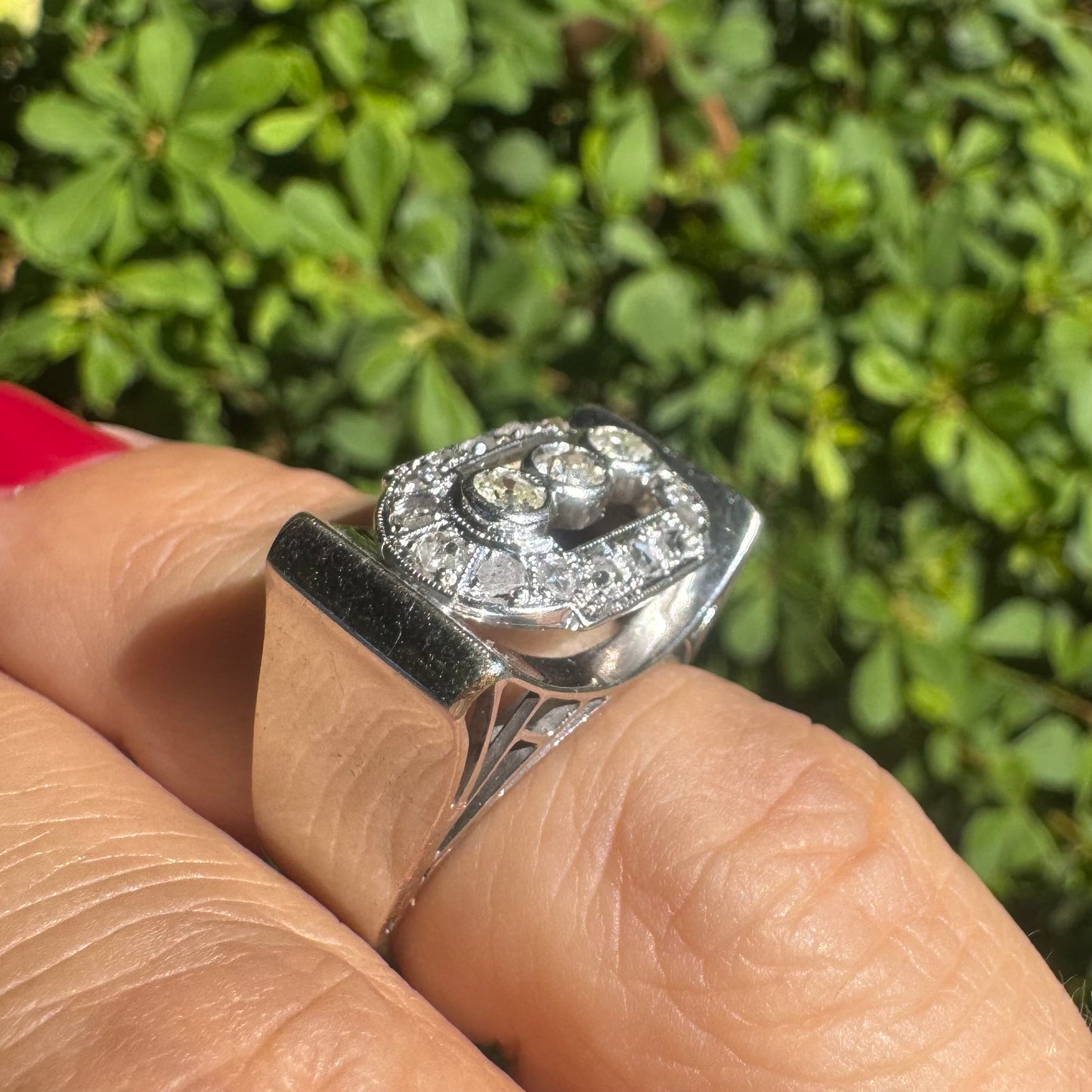 18K gold ring featuring three round 3 Diamonds in the center, framed by a rectangular halo of smaller Diamonds.