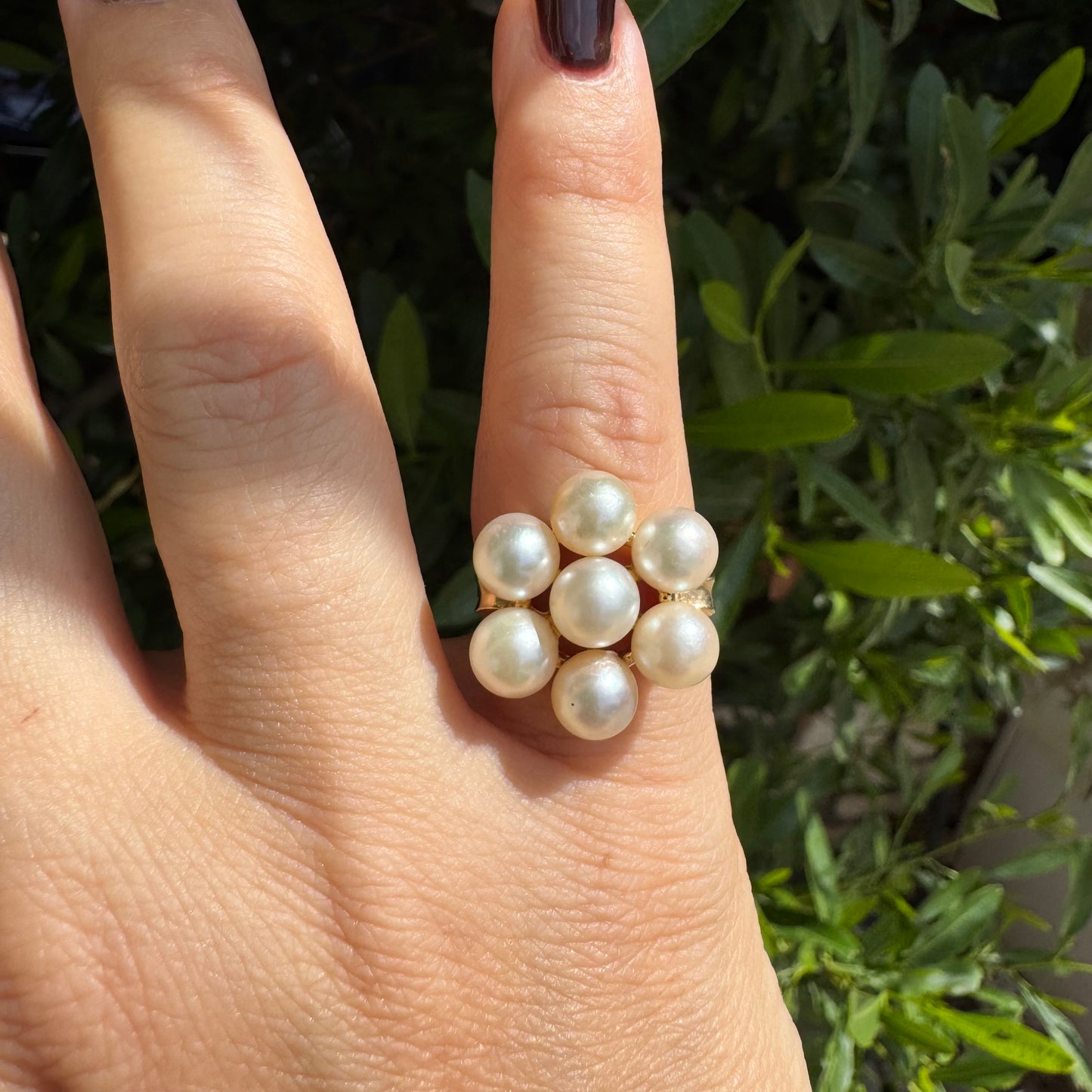 14K gold ring set with seven round Pearls in a bold floral cluster