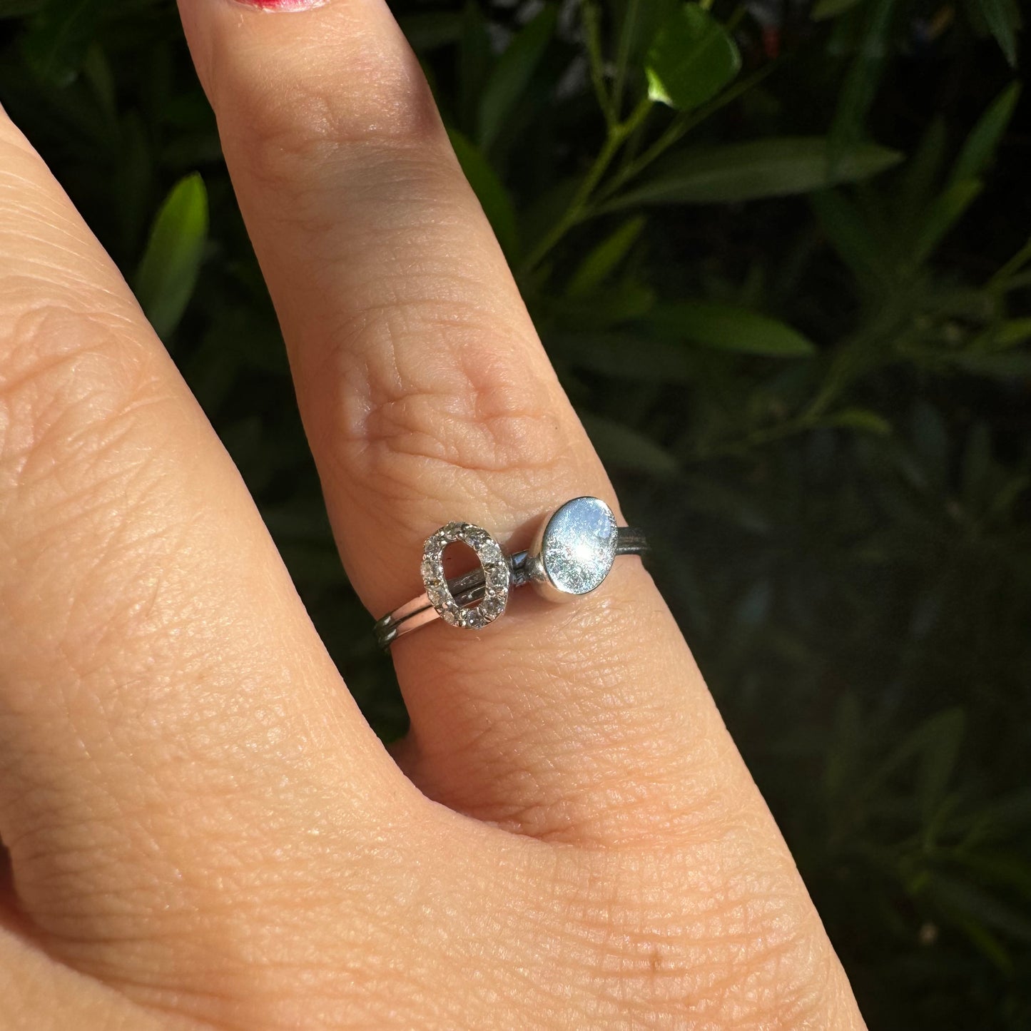 14K gold open ring featuring two ends: one with a sparkling oval of Diamonds and the other with a smooth polished oval.