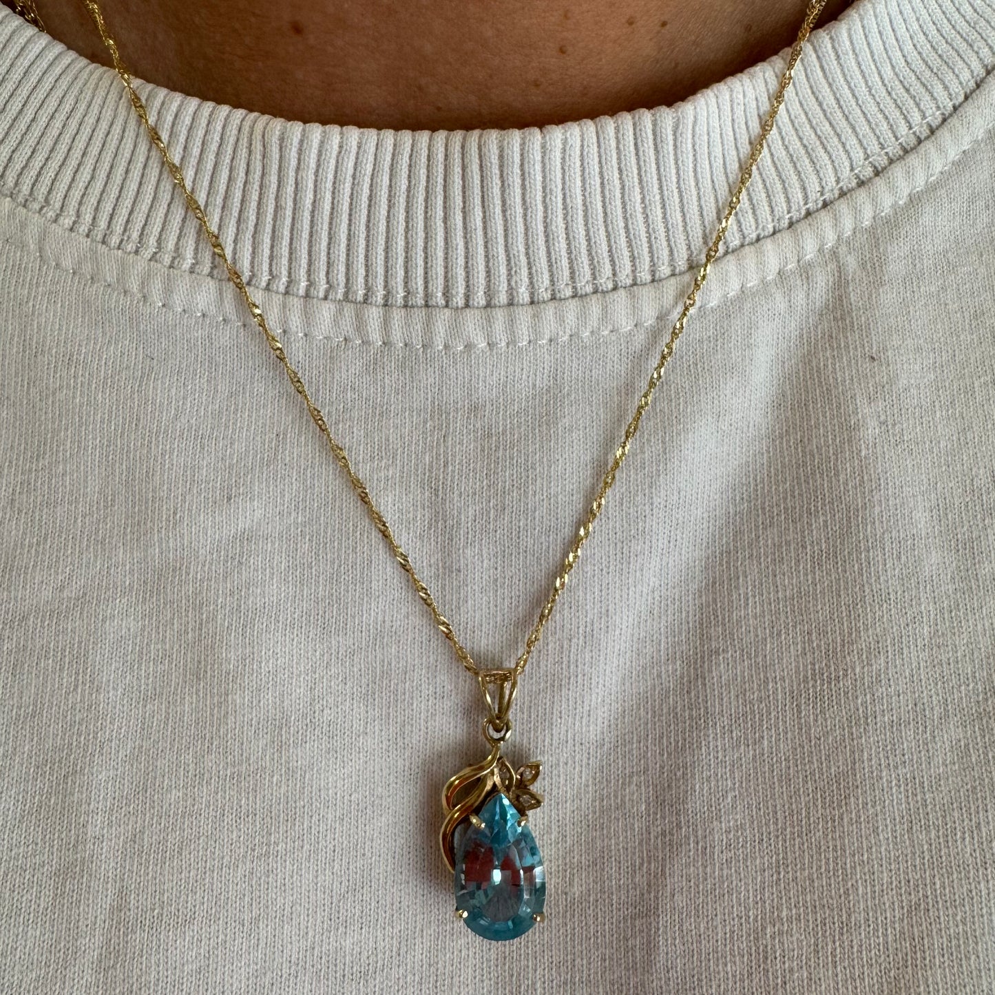 14K gold necklace set with Blue Topaz pendant in a teardrop cut