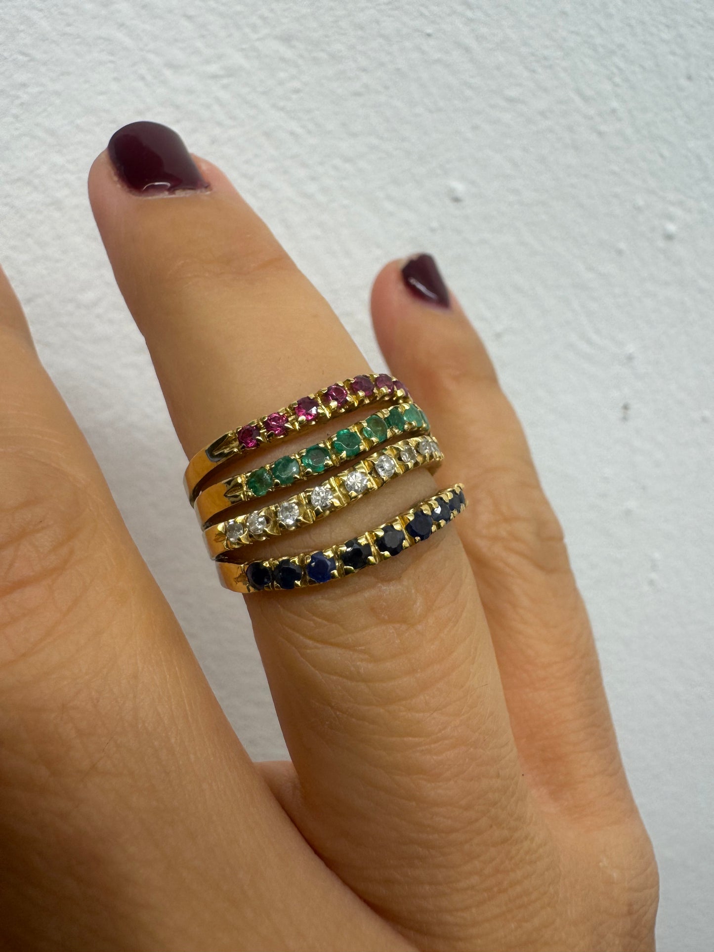 18K yellow gold ring set with vibrant rows of Sapphires, Emeralds, Rubies, and Diamonds