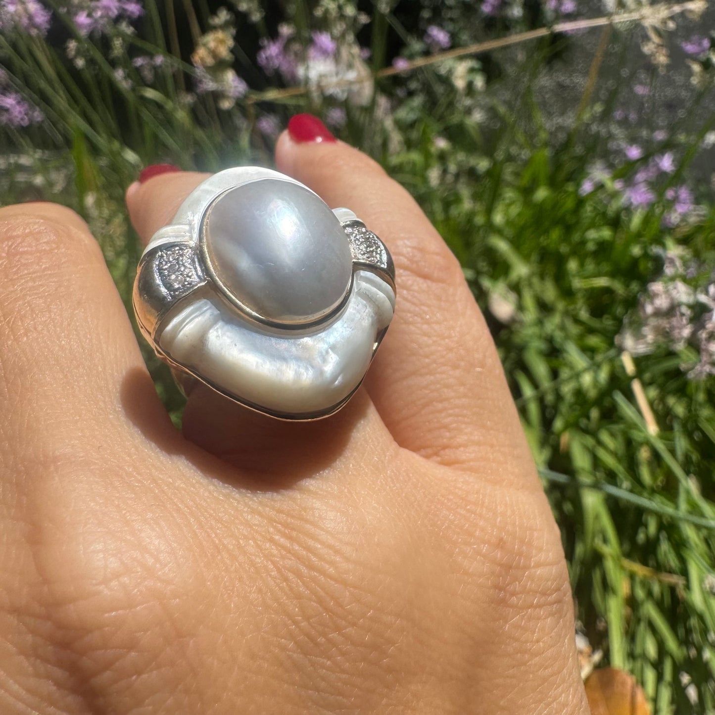 14K gold ring set with a natural mother-of-pearl centerpiece framed by delicate diamond accents