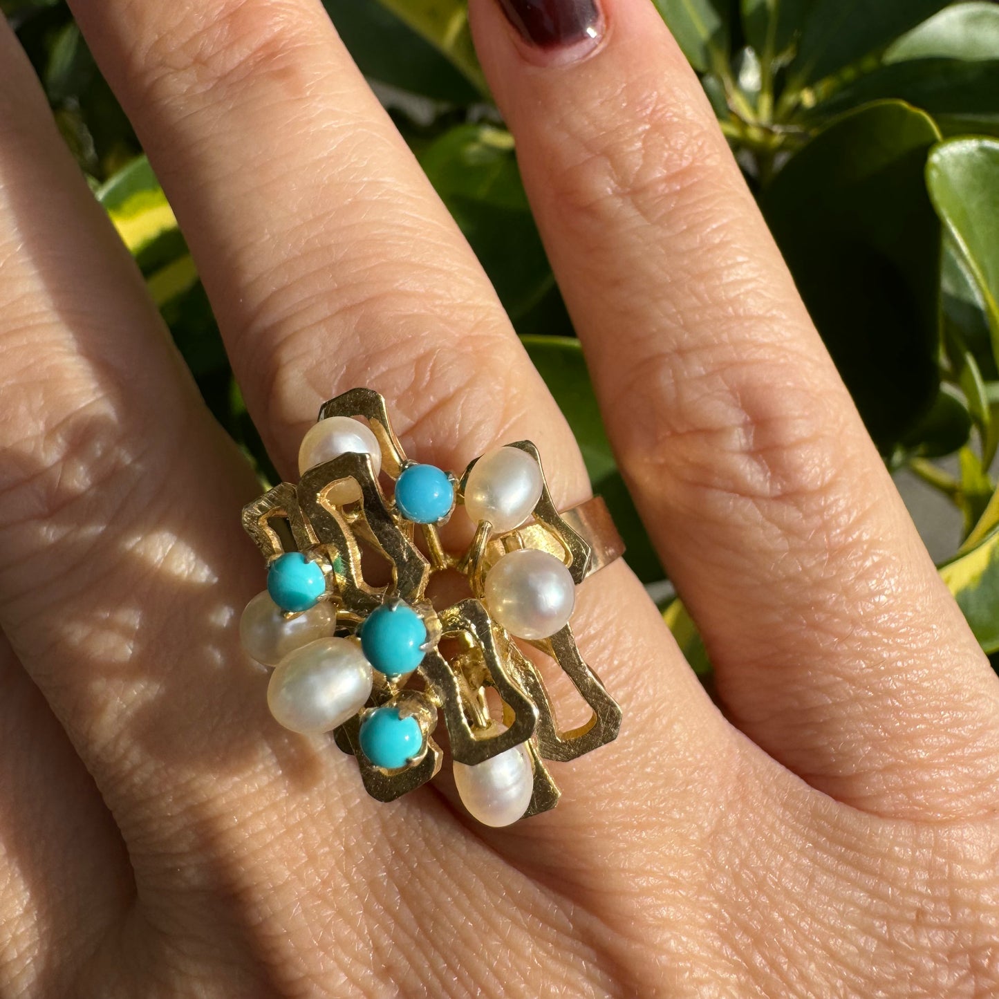 14K gold ring with a textured design, set with round white pearls and turquoise stones for a striking contrast.