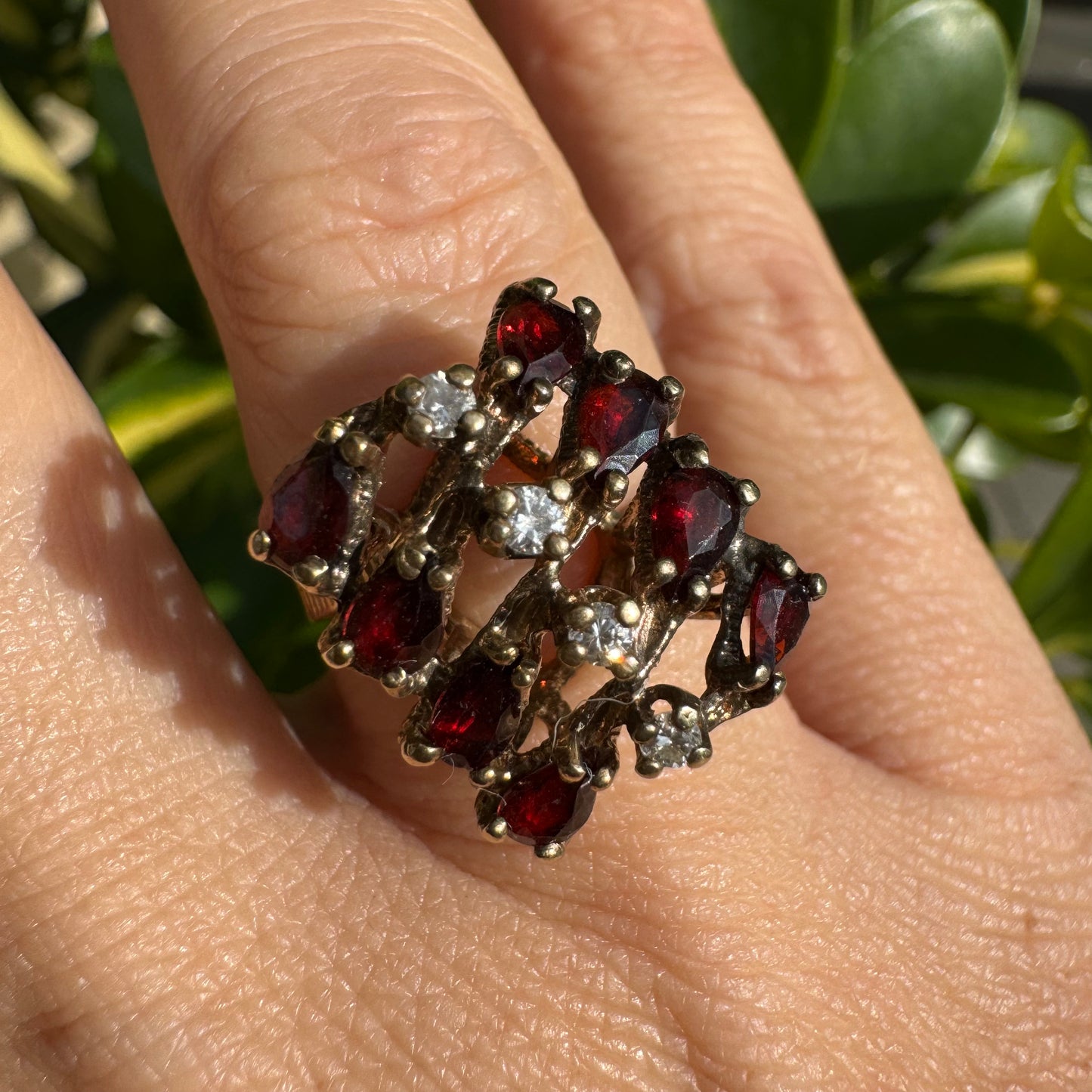 14K gold ring set with deep red teardrop Garnets and sparkling Diamonds in an openwork geometric design