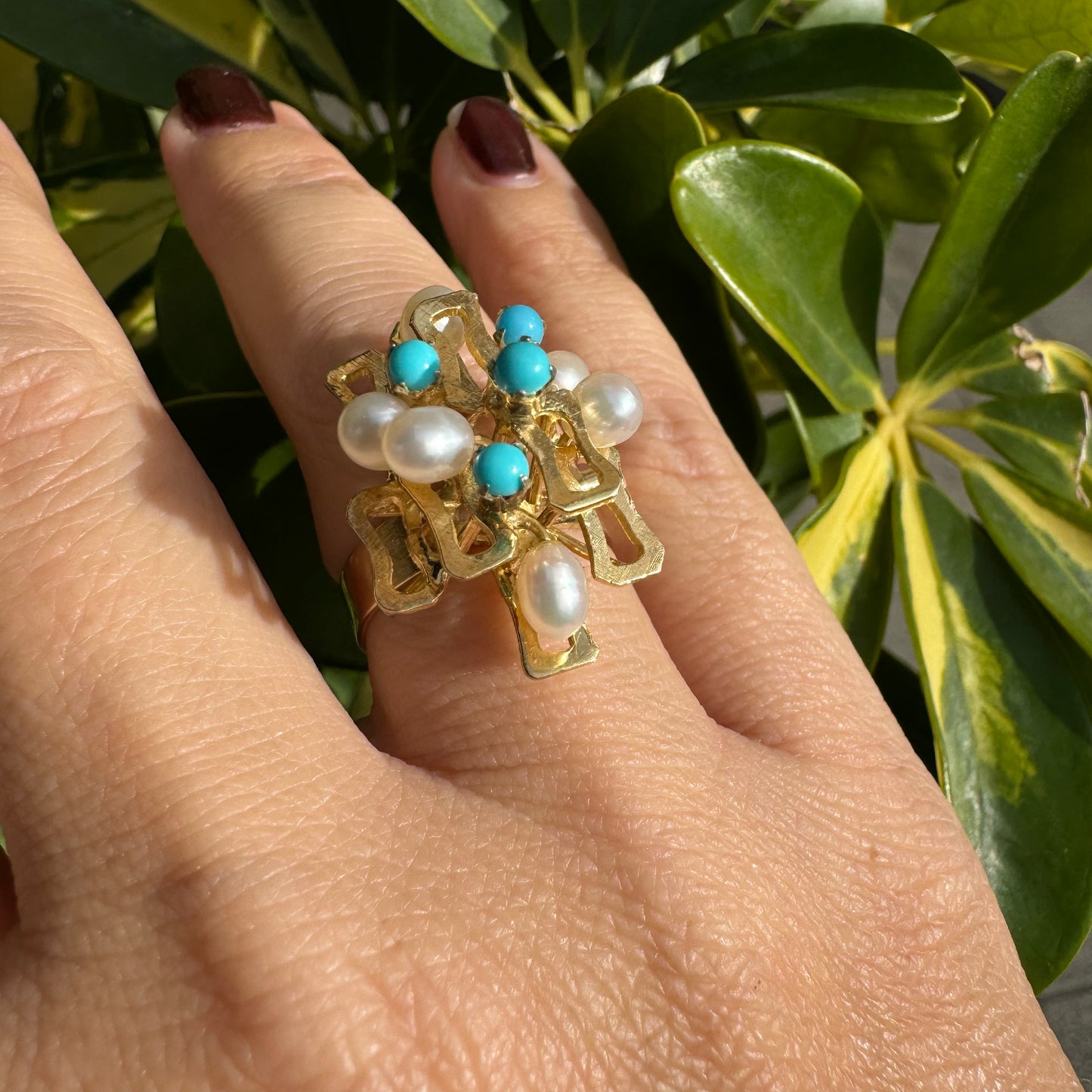 14K gold ring with a textured design, set with round white pearls and turquoise stones for a striking contrast.