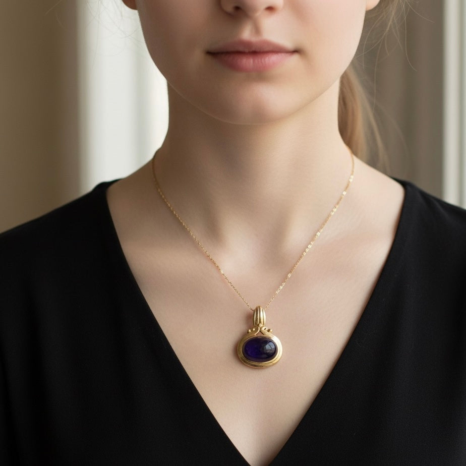 14K gold pendant set with a large cabochon Amethyst