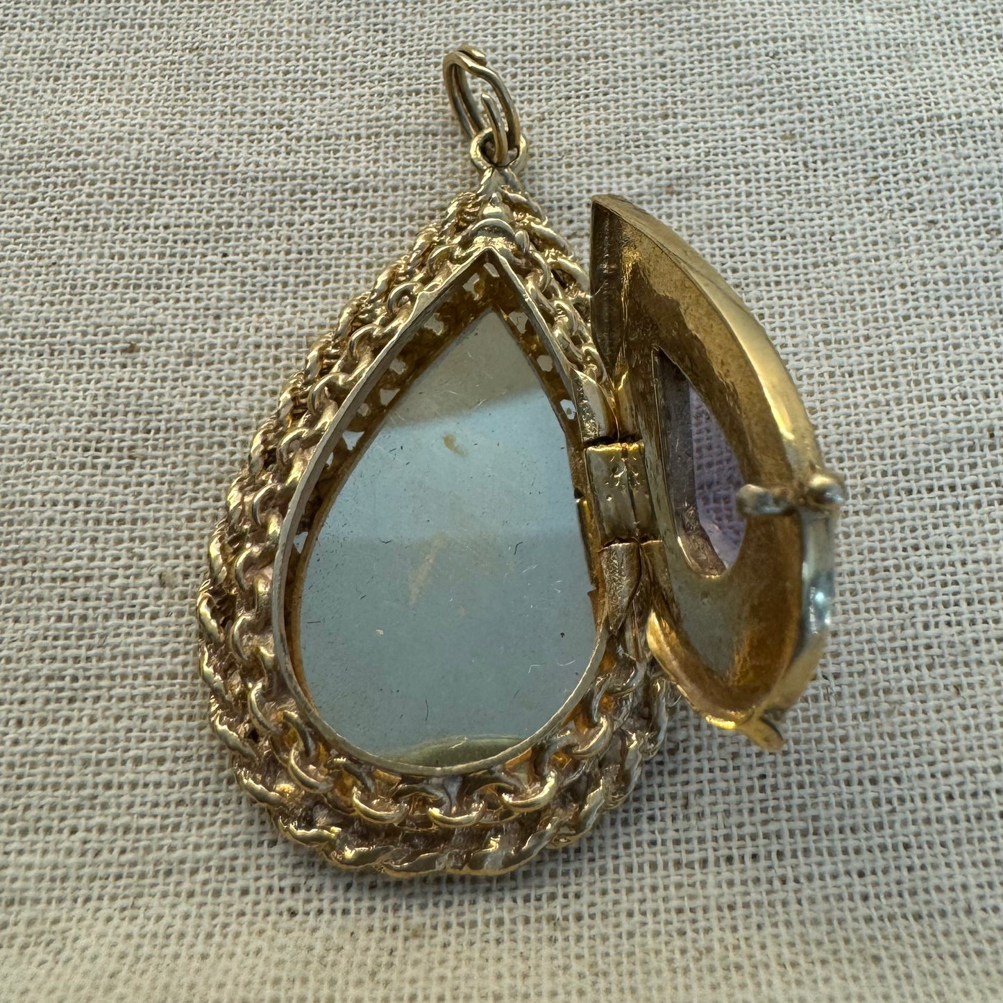 14K gold locket pendant set with an Amethyst gemstone