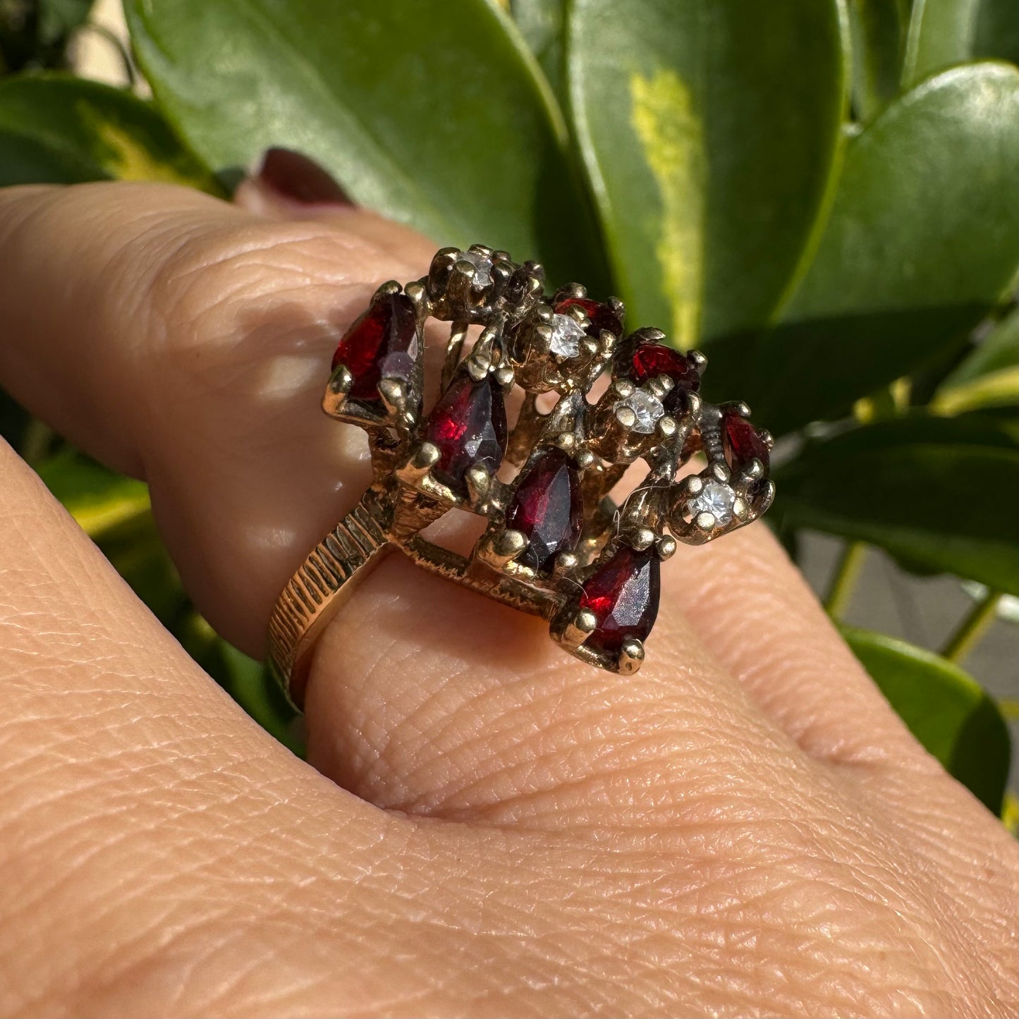 14K gold ring set with deep red teardrop Garnets and sparkling Diamonds in an openwork geometric design