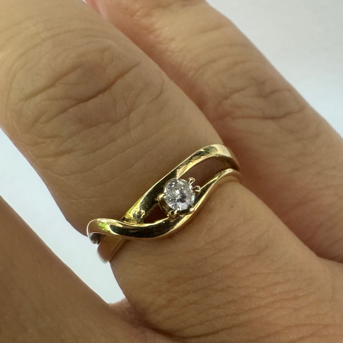 14K gold ring set with a single brilliant-cut diamond