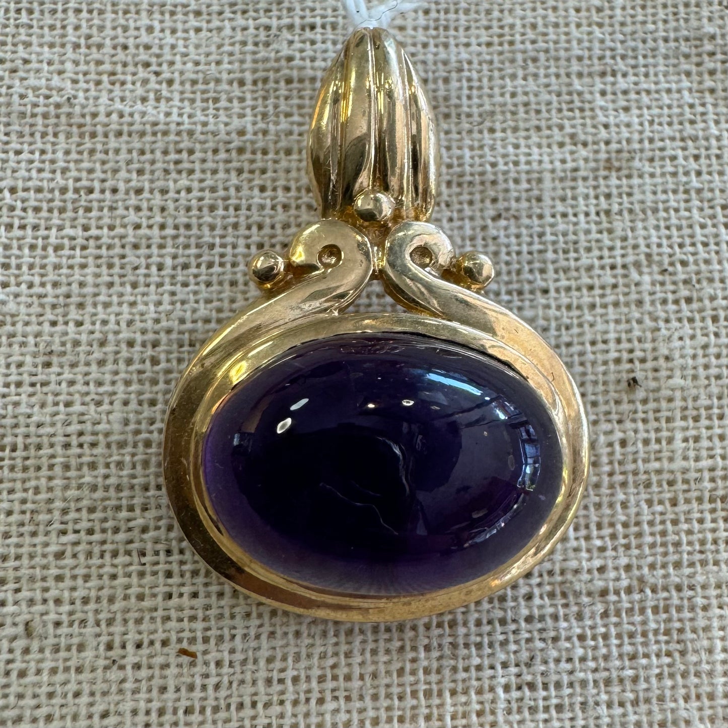 14K gold pendant set with a large cabochon Amethyst