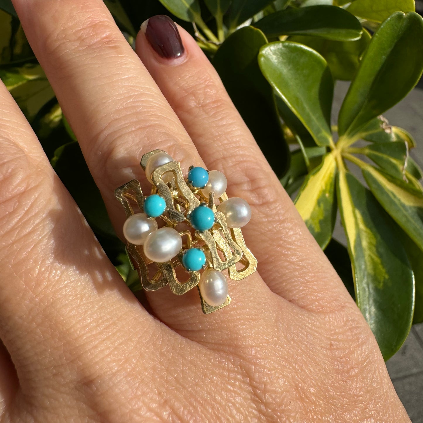 14K gold ring with a textured design, set with round white pearls and turquoise stones for a striking contrast.
