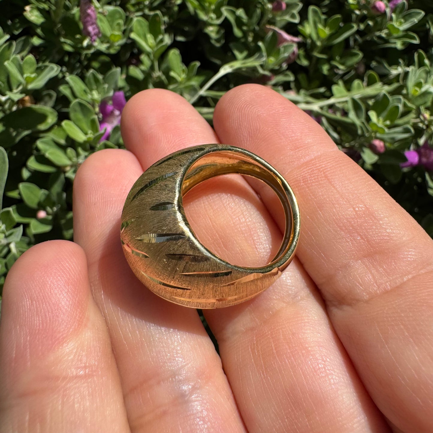 14K gold dome ring crafted in textured gold, featuring intricate engraved starburst detailing