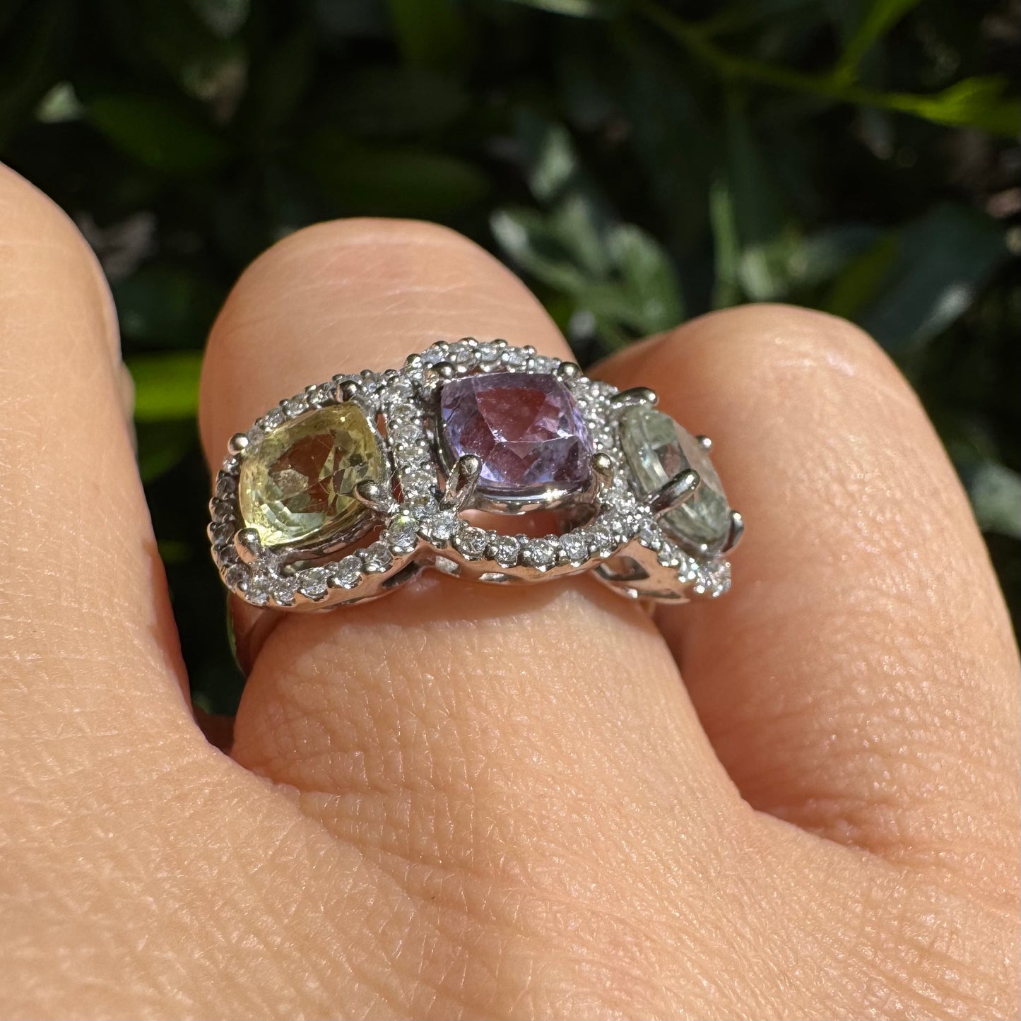 18K gold ring set with three pastel gemstones in soft shades of lilac, yellow and light gray