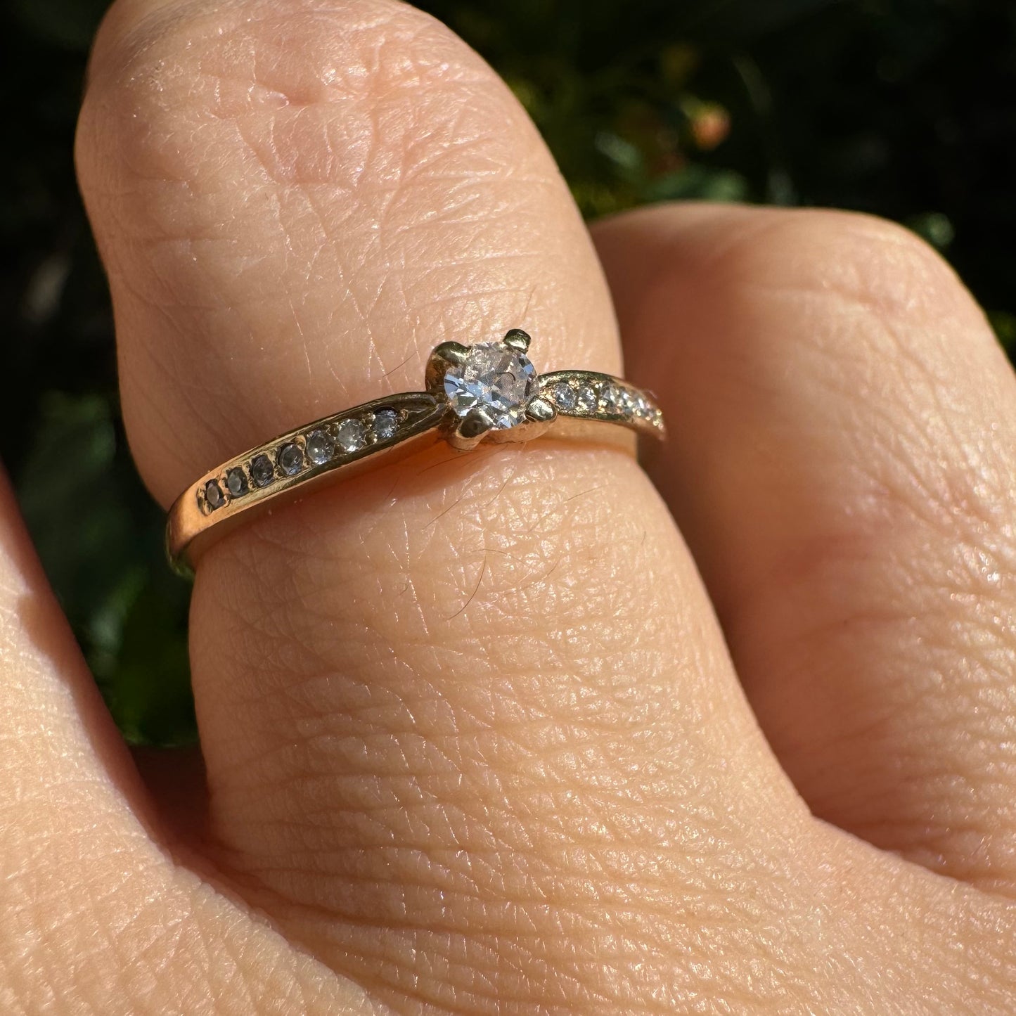 14K gold ring set with one center Diamond and side Diamonds