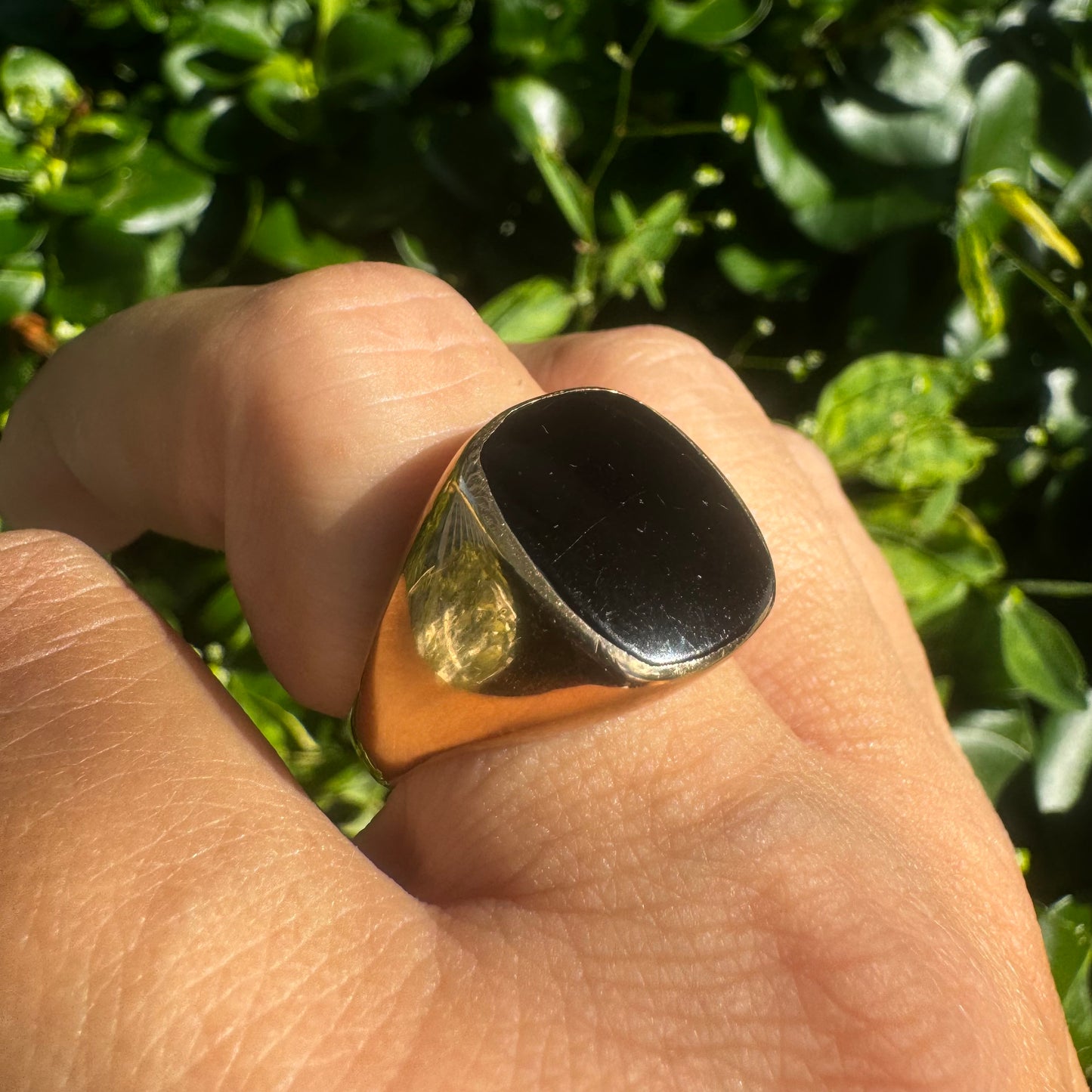 14K bold gold ring set with a smooth, square-shaped black Onyx that creates a sleek and striking look.