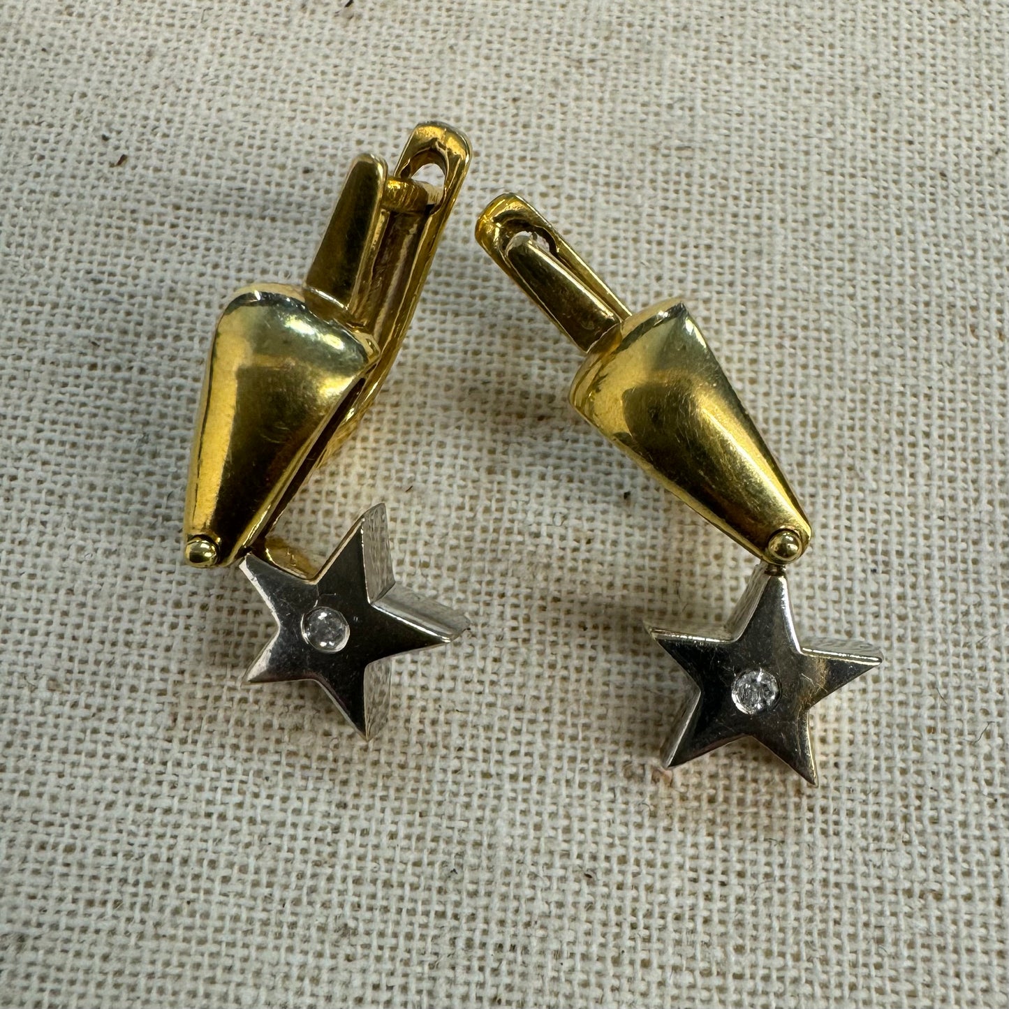 18K gold earrings set with a sparkling Diamond at the center.