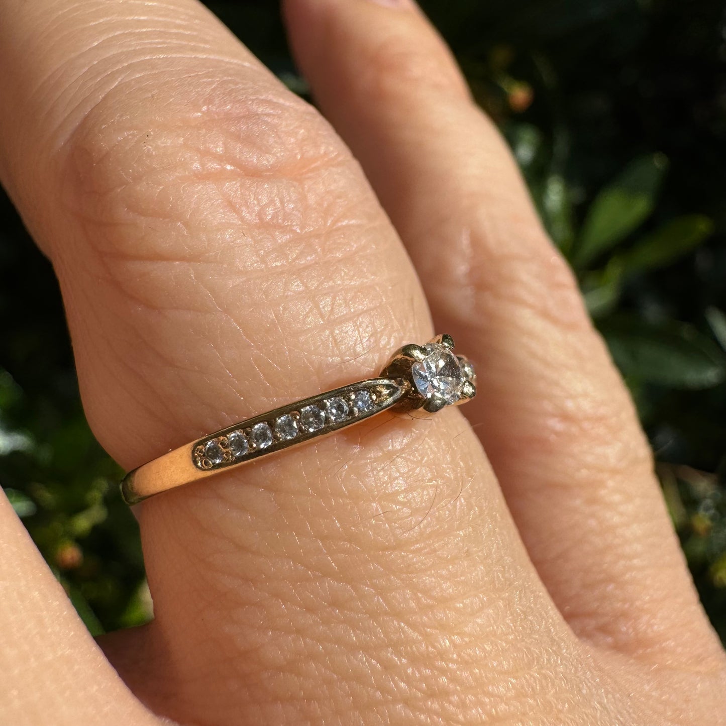 14K gold ring set with one center Diamond and side Diamonds