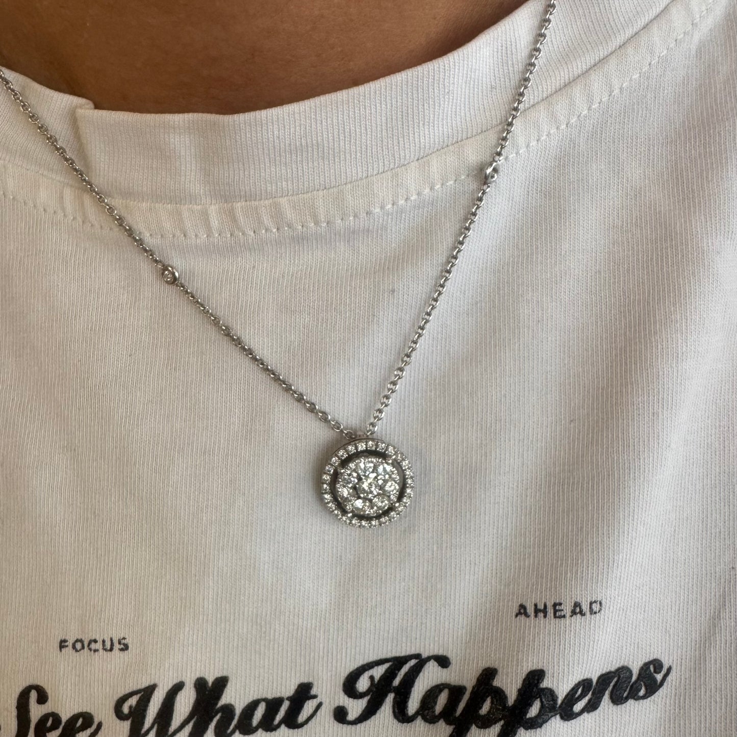 14K gold necklace featuring a round pendant set with a cluster of sparkling Diamonds