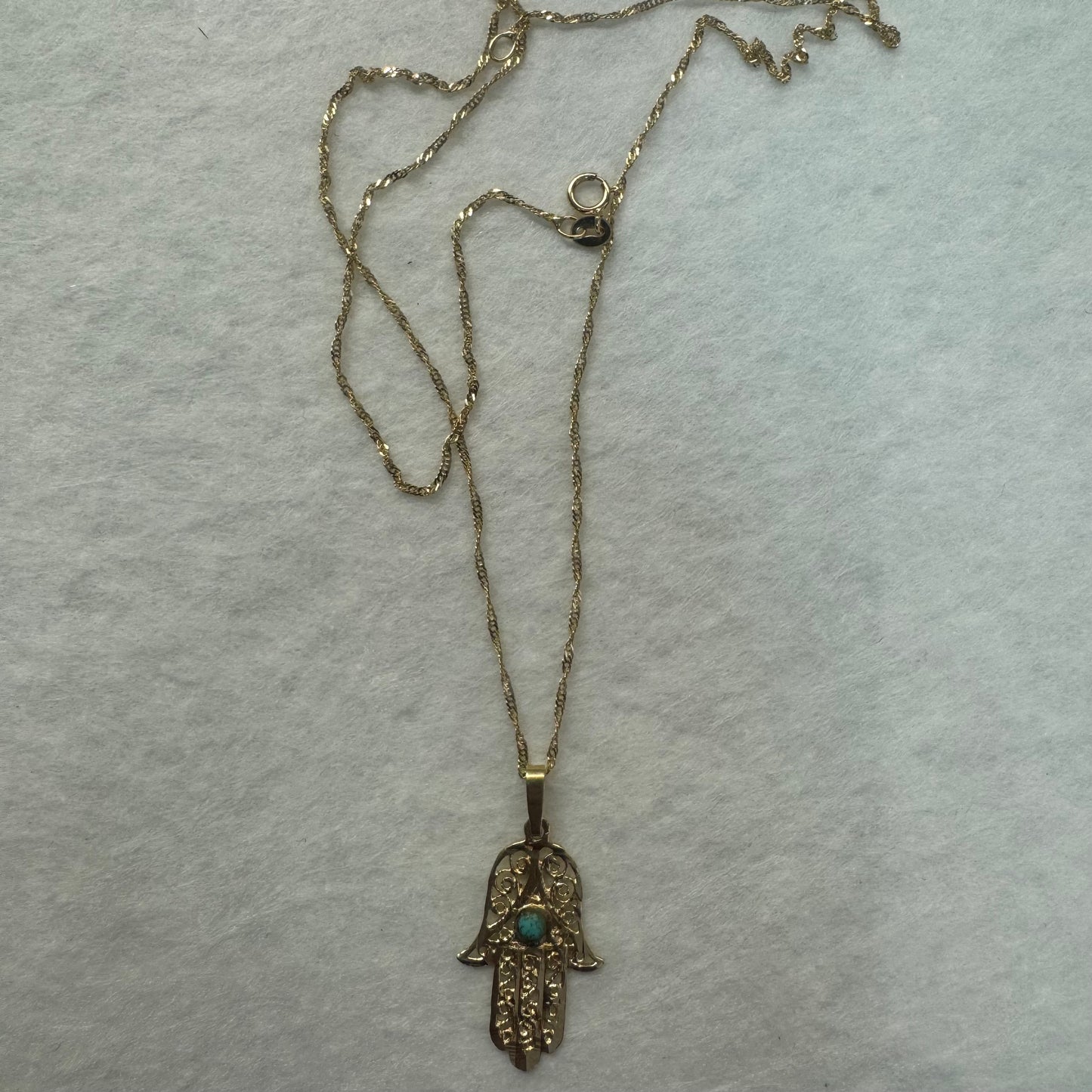 14K gold necklace with “Hamsa” pendant set with a center Turquoise stone