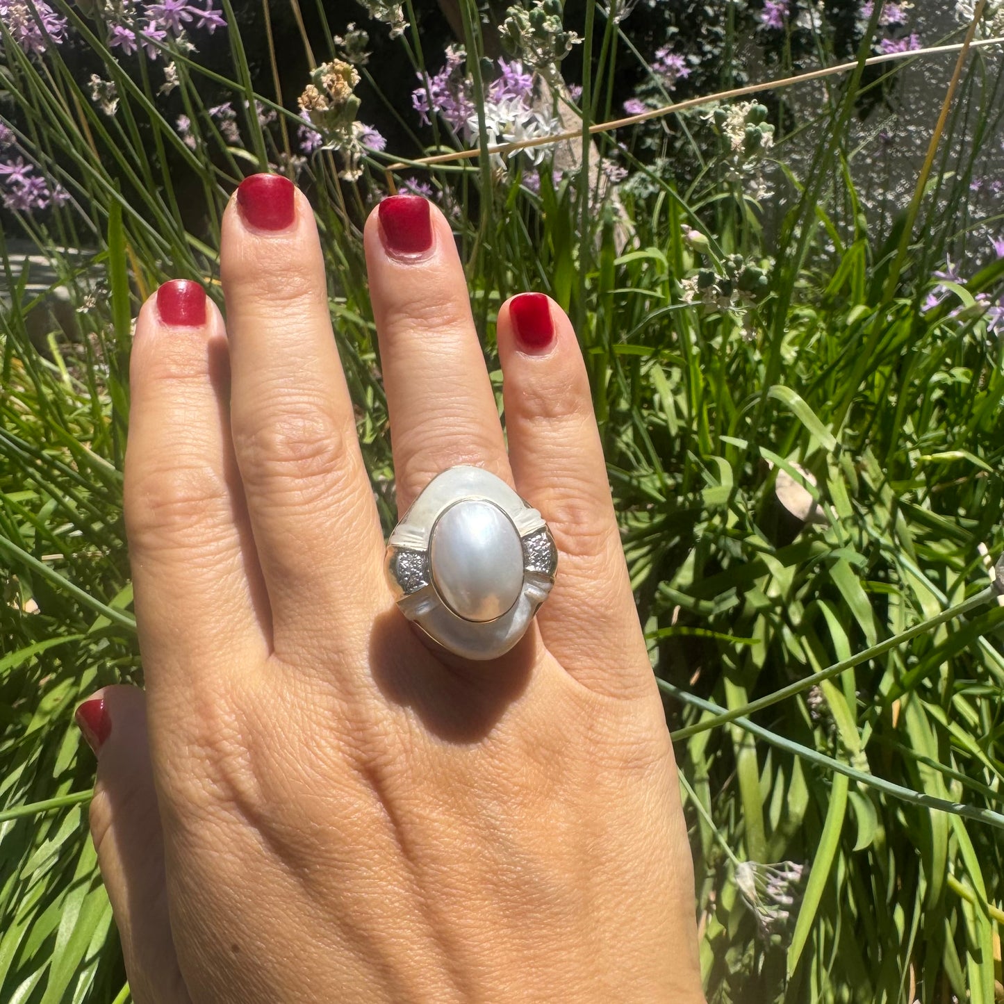 14K gold ring set with a natural mother-of-pearl centerpiece framed by delicate diamond accents