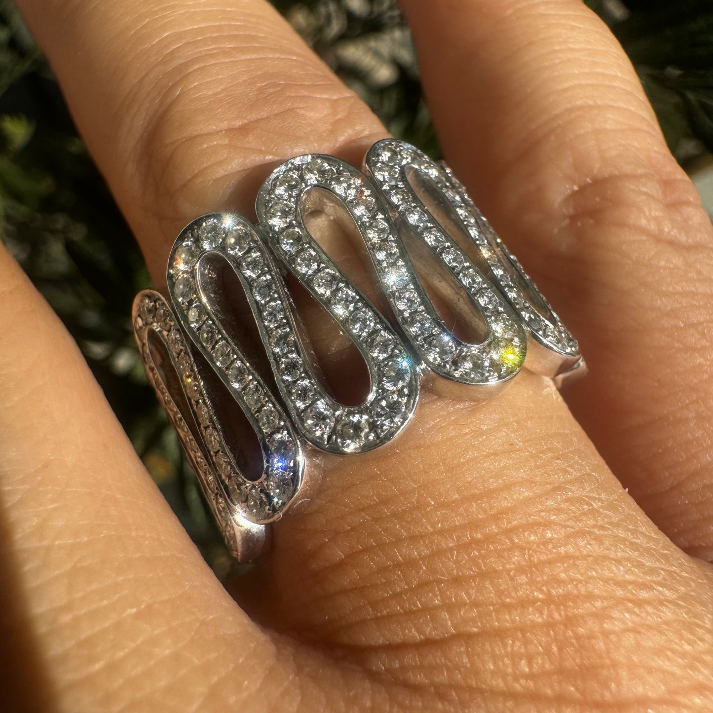 14K gold ring set with shimmering Diamonds in a flowing wave design