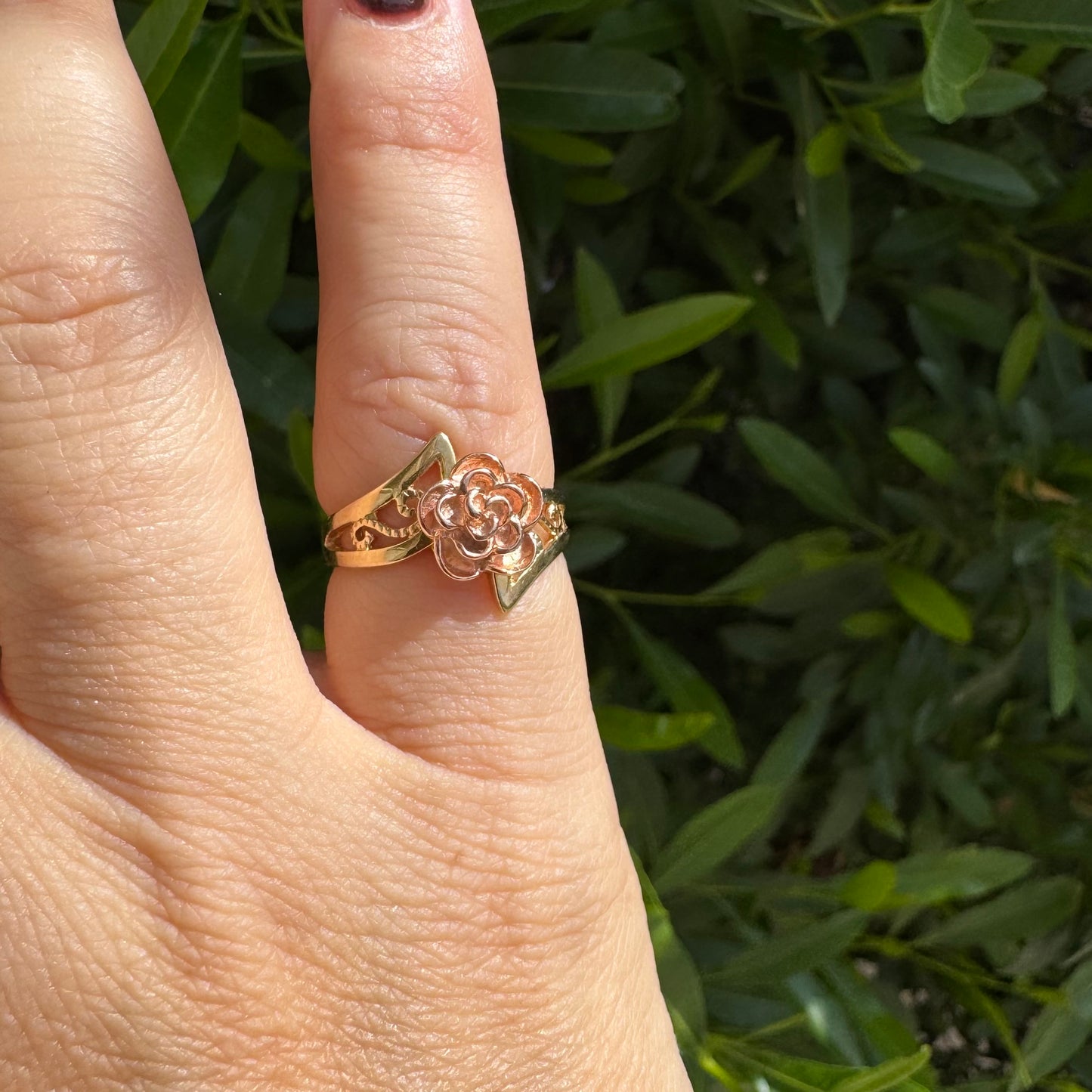 10K two tone gold with a sculpted rose at its center