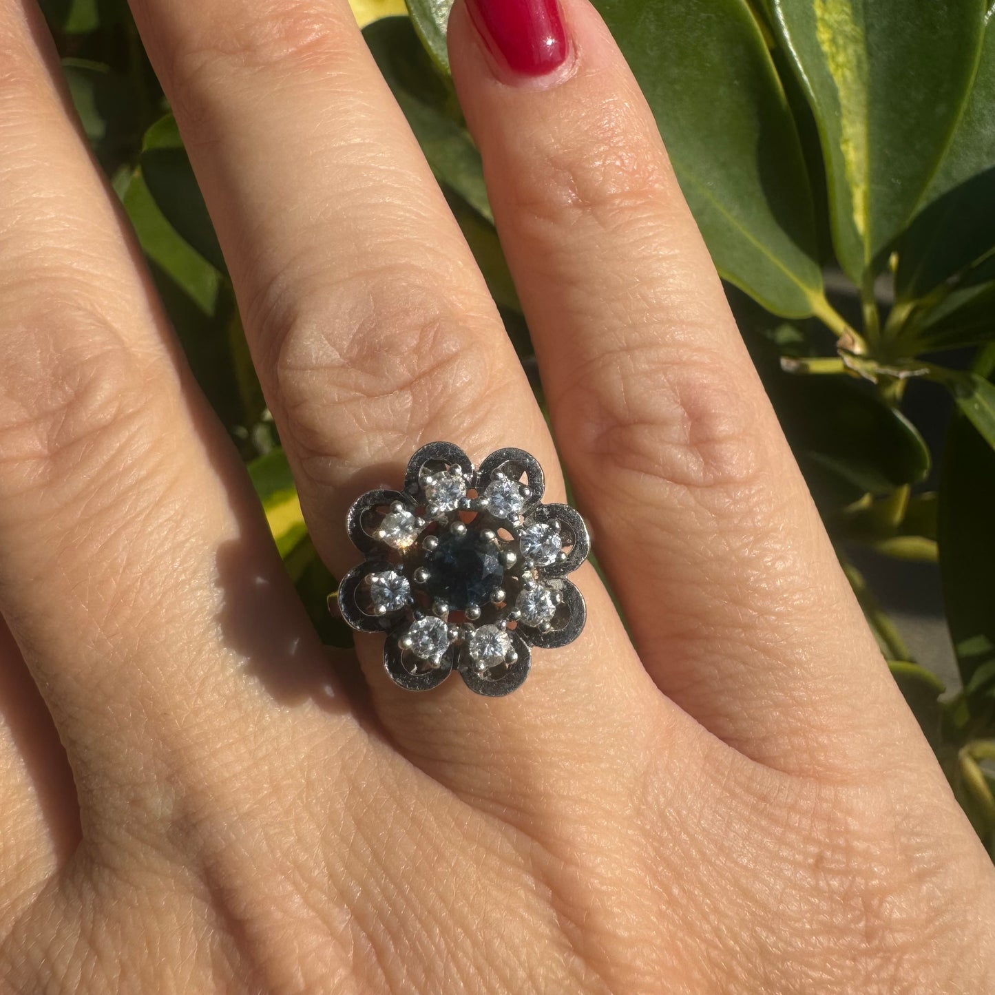 14K gold floral ring set with a round deep blue Sapphire at its center & Diamonds